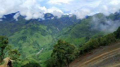 Trail climbing through hills toward Khayang Peak