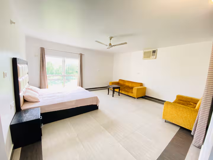 High-ceilinged bedroom at Heritage Villa Imphal