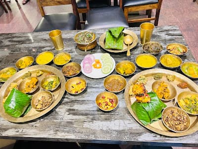 A full Manipuri feast laid out on leaf plates for Ningol Chakouba