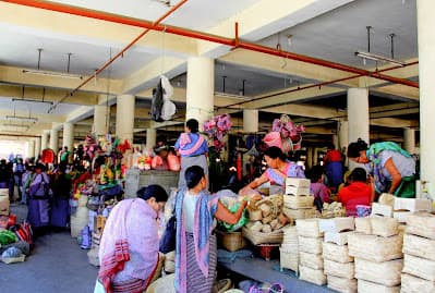 Vendors and sacks of produce filling the aisles of Ima Keithel